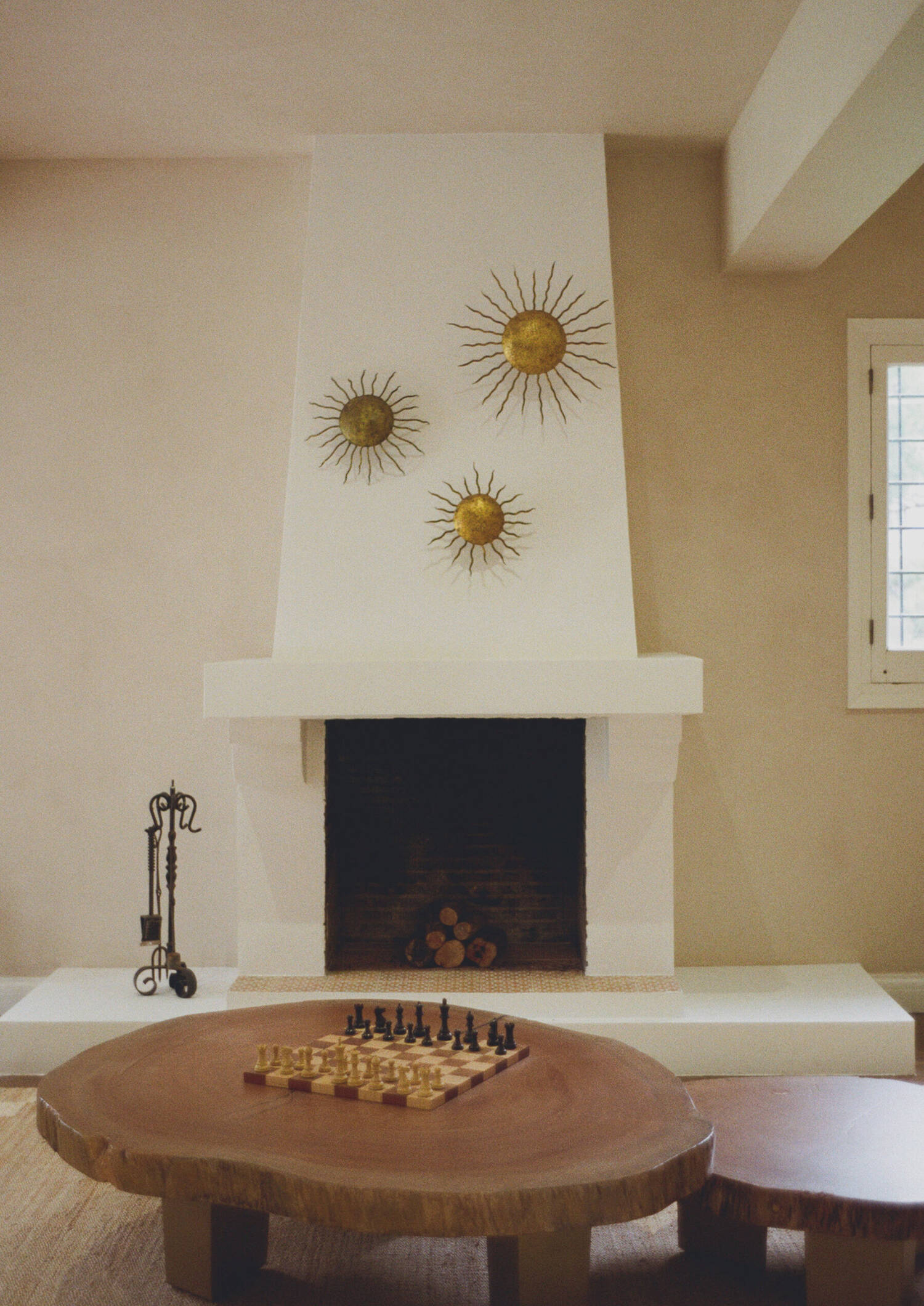 Sculpted plaster fireplace with gilded sun mirrors